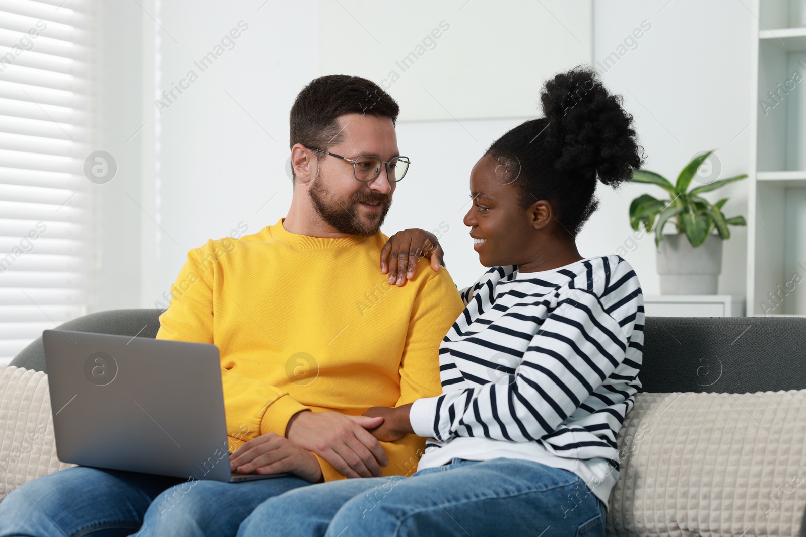 Photo of International relationships. Lovely couple spending time together at home