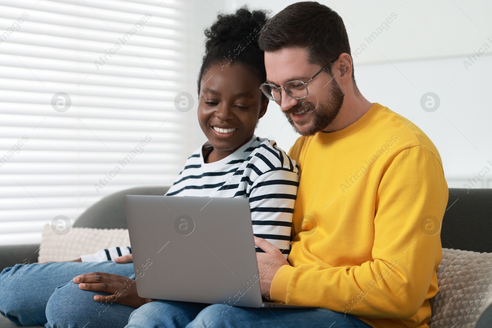 Photo of International relationships. Lovely couple spending time together at home