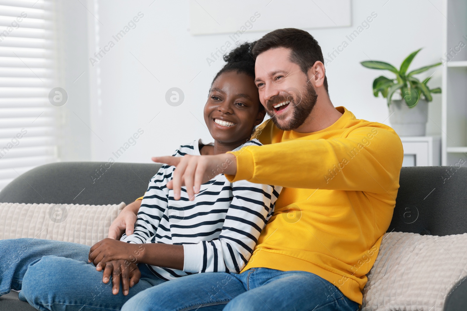 Photo of International relationships. Lovely couple spending time together at home