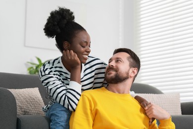 Photo of International relationships. Portrait of lovely couple at home