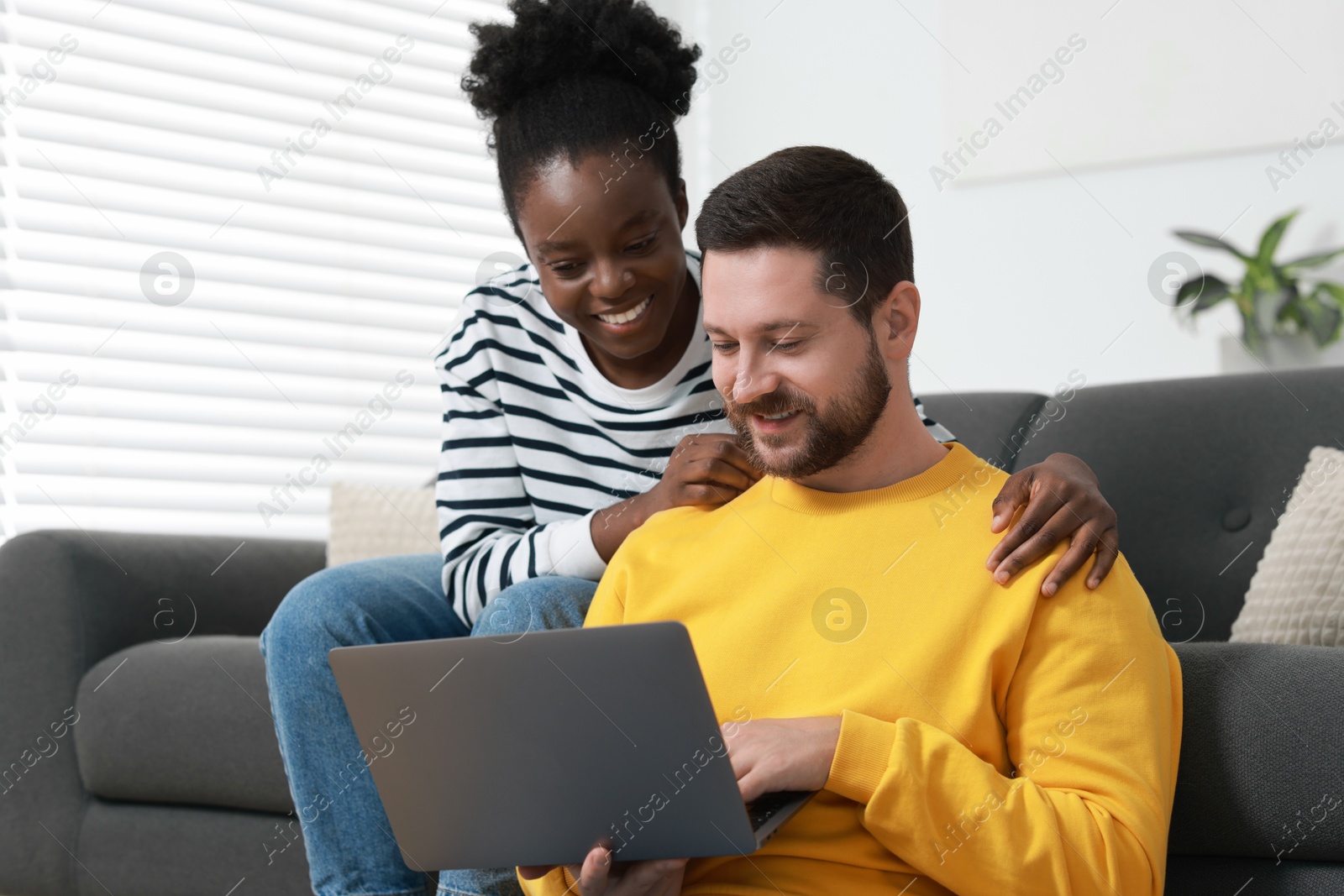 Photo of International relationships. Lovely couple spending time together at home