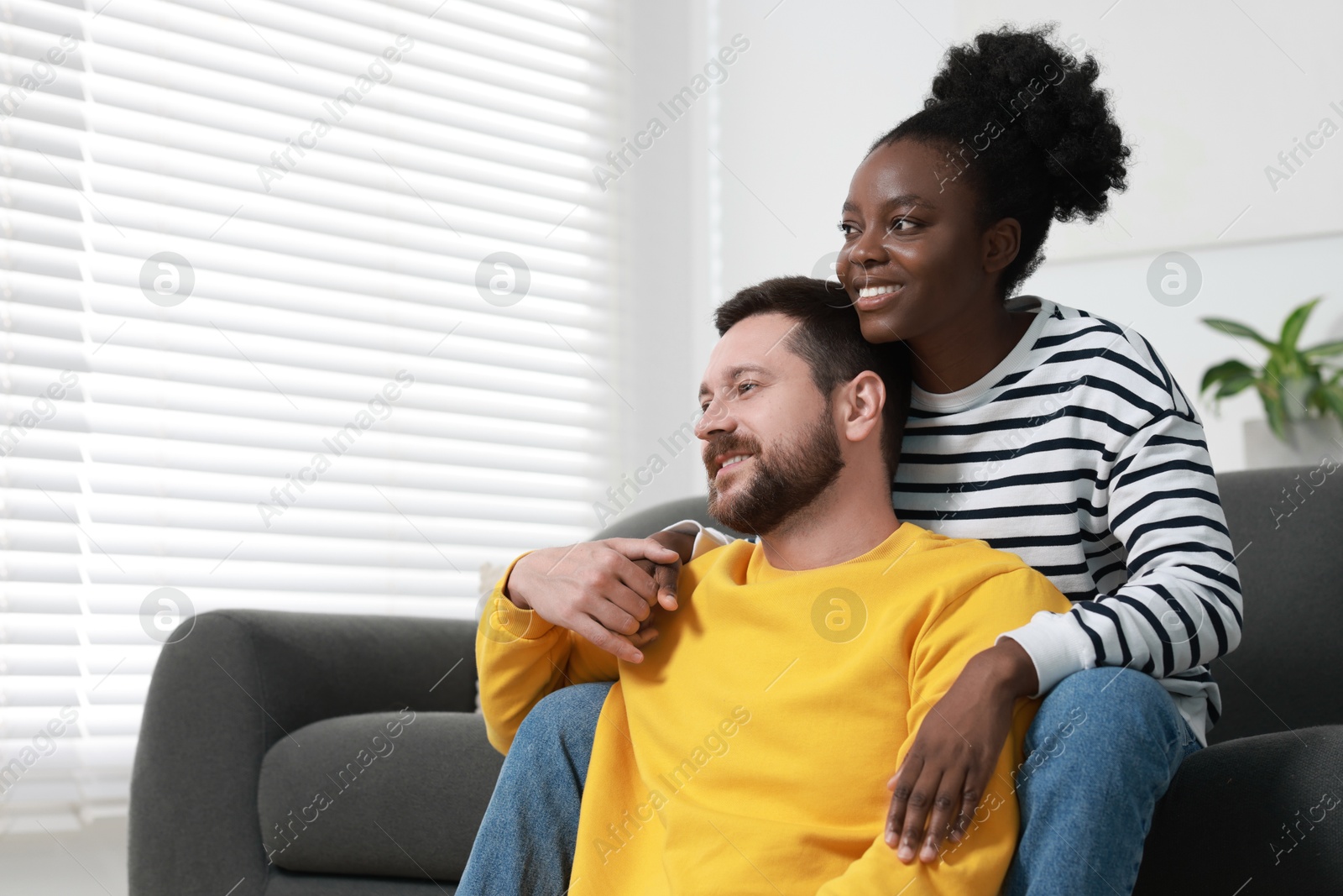 Photo of International relationships. Portrait of lovely couple at home