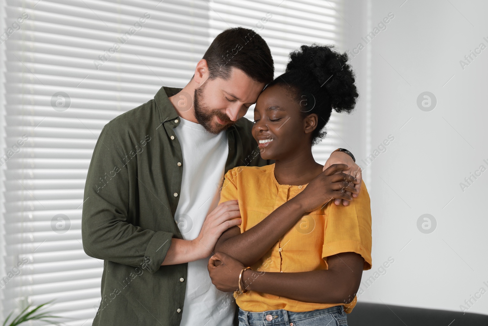 Photo of International relationships. Portrait of lovely couple at home