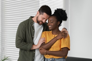 International relationships. Portrait of lovely couple at home