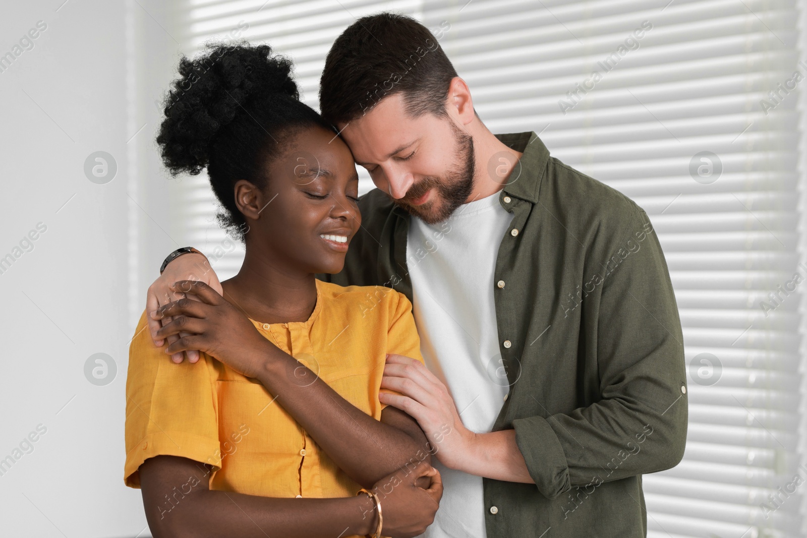 Photo of International relationships. Portrait of lovely couple at home