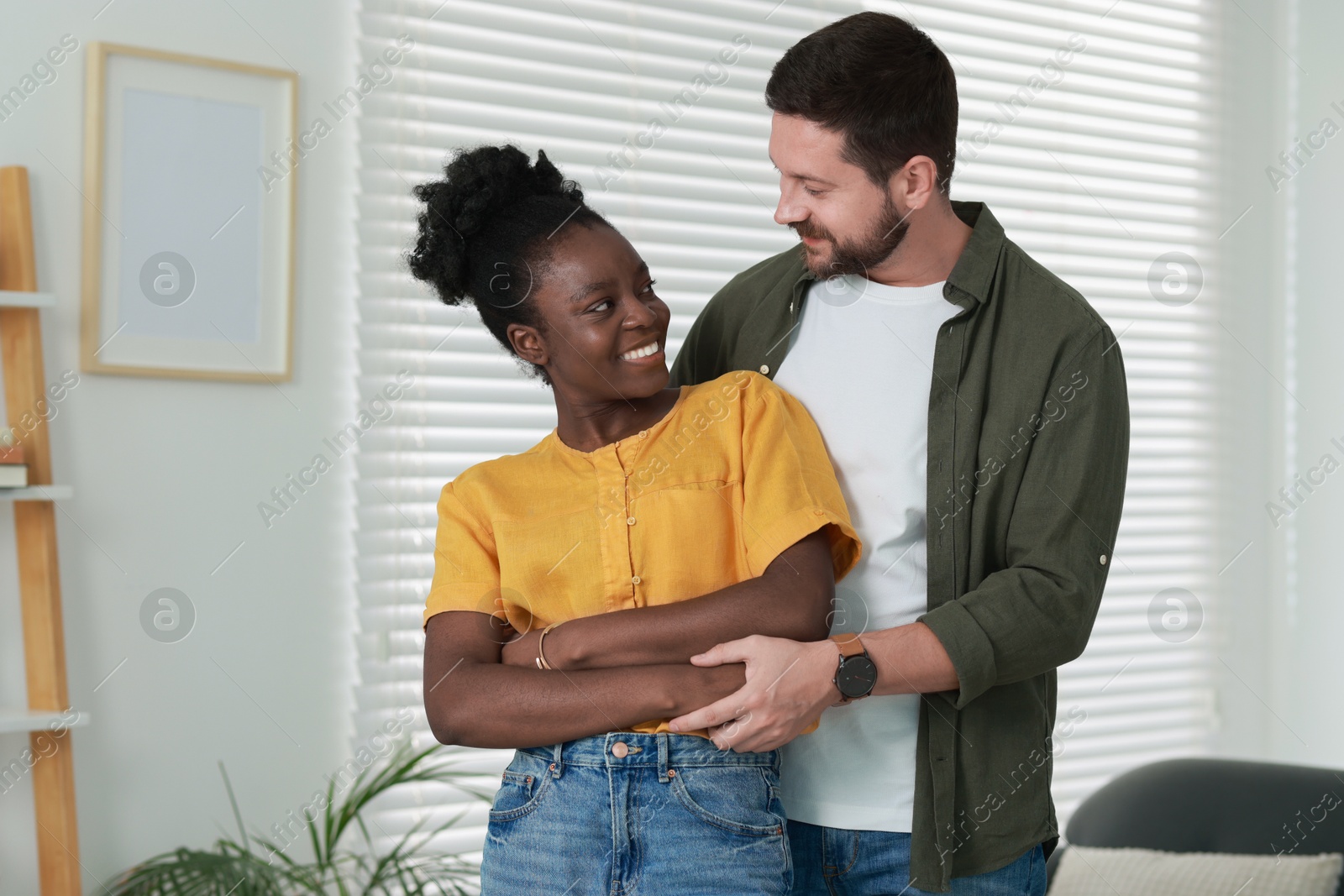 Photo of International relationships. Portrait of lovely couple at home