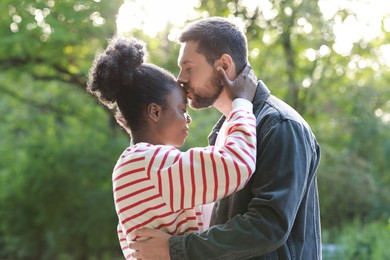 International relationships. Portrait of lovely couple outdoors