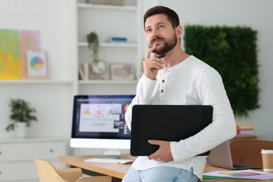 Professional designer with tablet in modern office