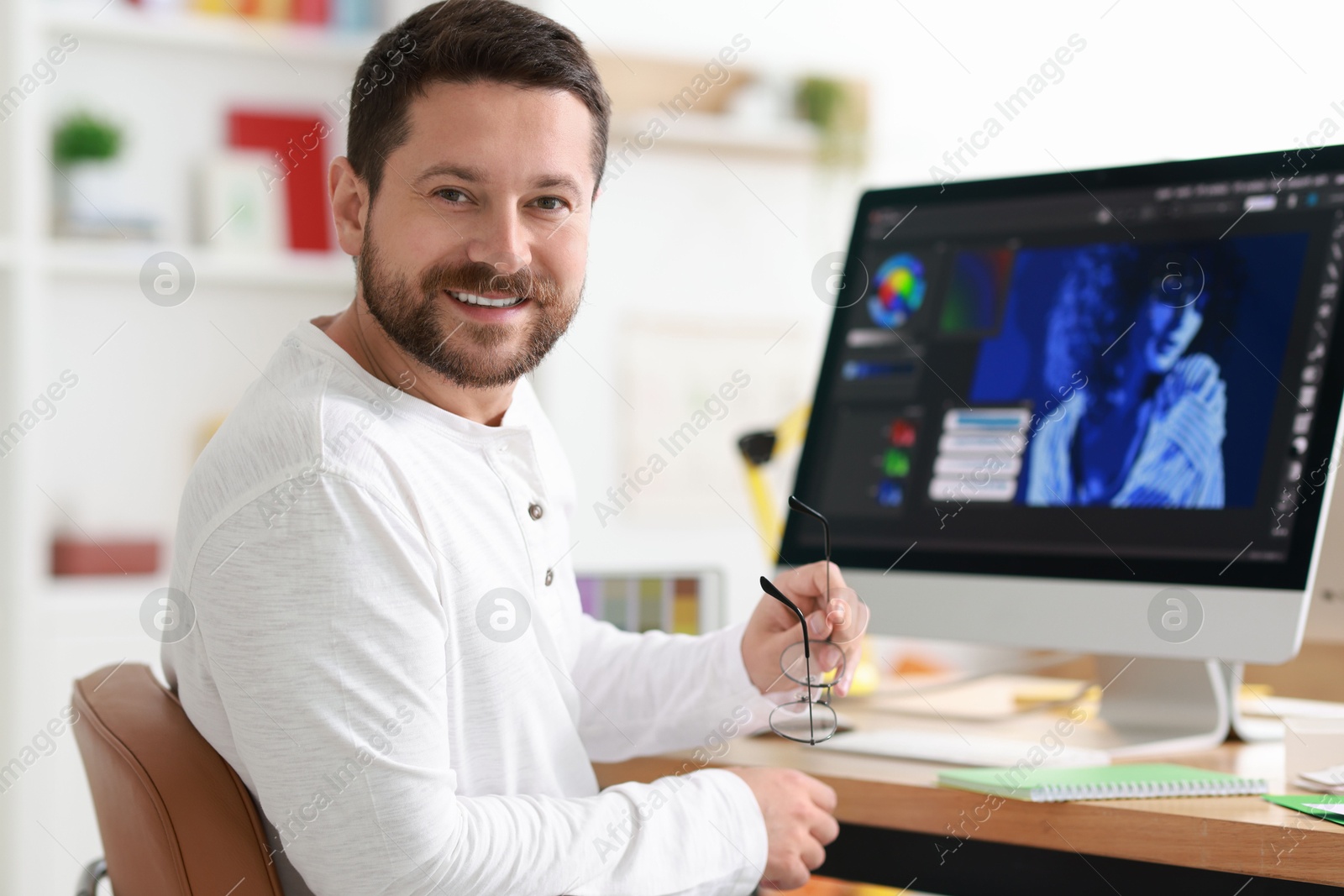 Photo of Designer working with computer at table in office