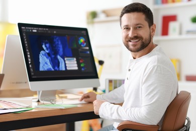 Photo of Designer working with computer at table in office