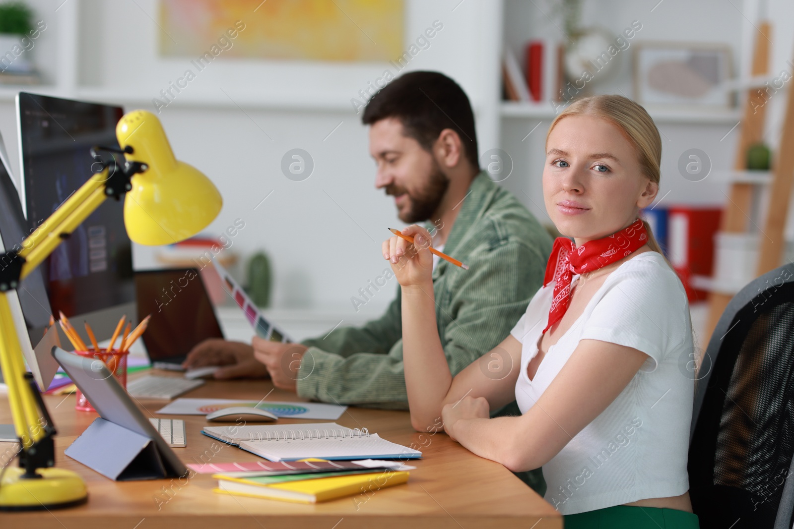 Photo of Designers working together at table in office, selective focus