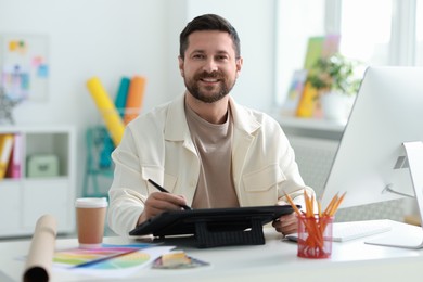 Designer working with tablet at table in office