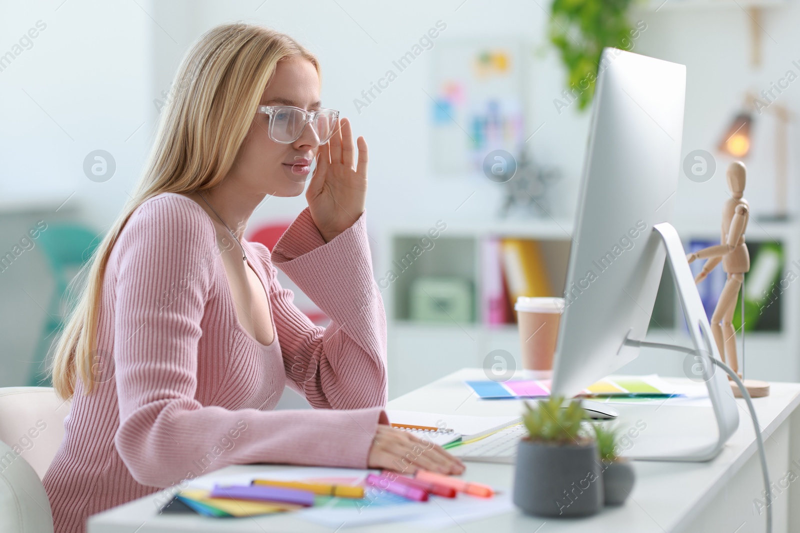 Photo of Designer working with computer at table in office