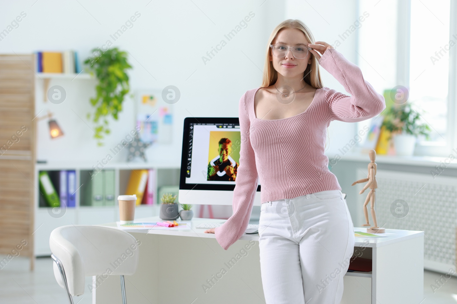 Photo of Portrait of beautiful young designer in office