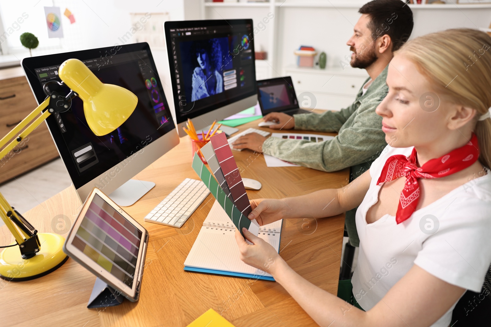 Photo of Designers working together at table in office