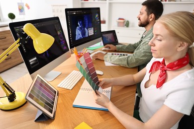 Photo of Designers working together at table in office