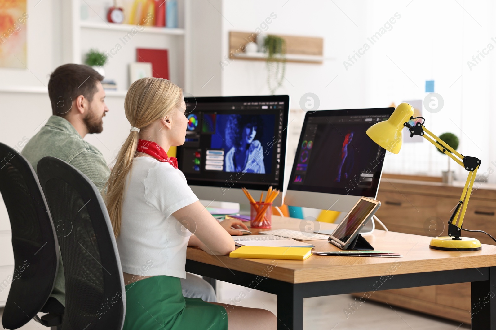 Photo of Designers working together at table in office