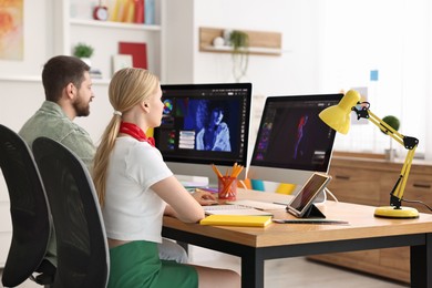 Photo of Designers working together at table in office