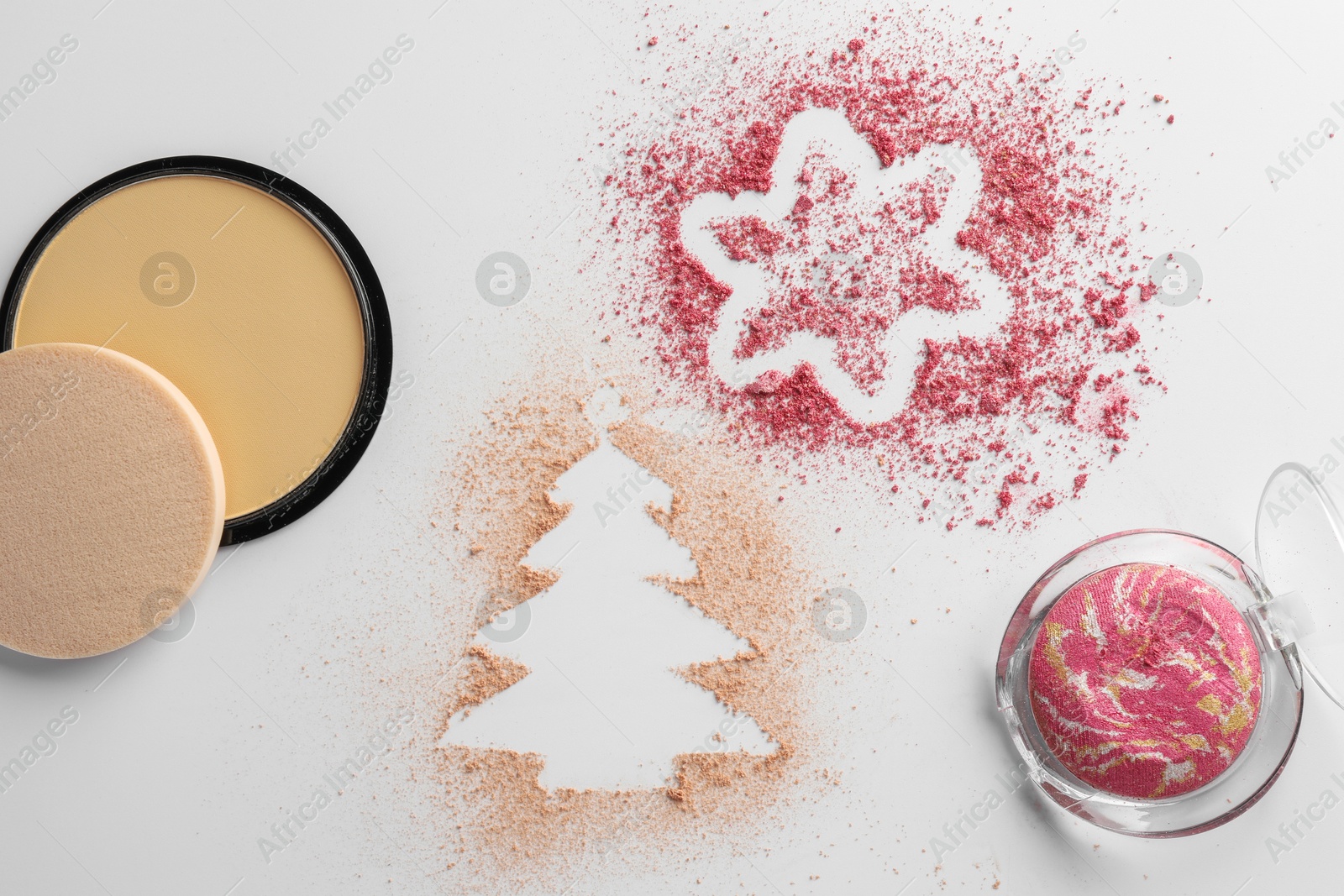 Photo of Christmas decorations made of powder and blush on white background, flat lay