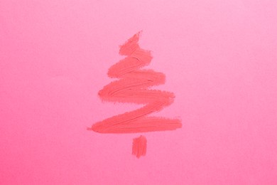 Photo of Christmas tree drawn with lipstick on pink background, top view