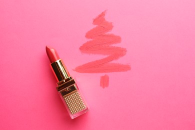 Photo of Christmas tree drawn with lipstick on pink background, top view