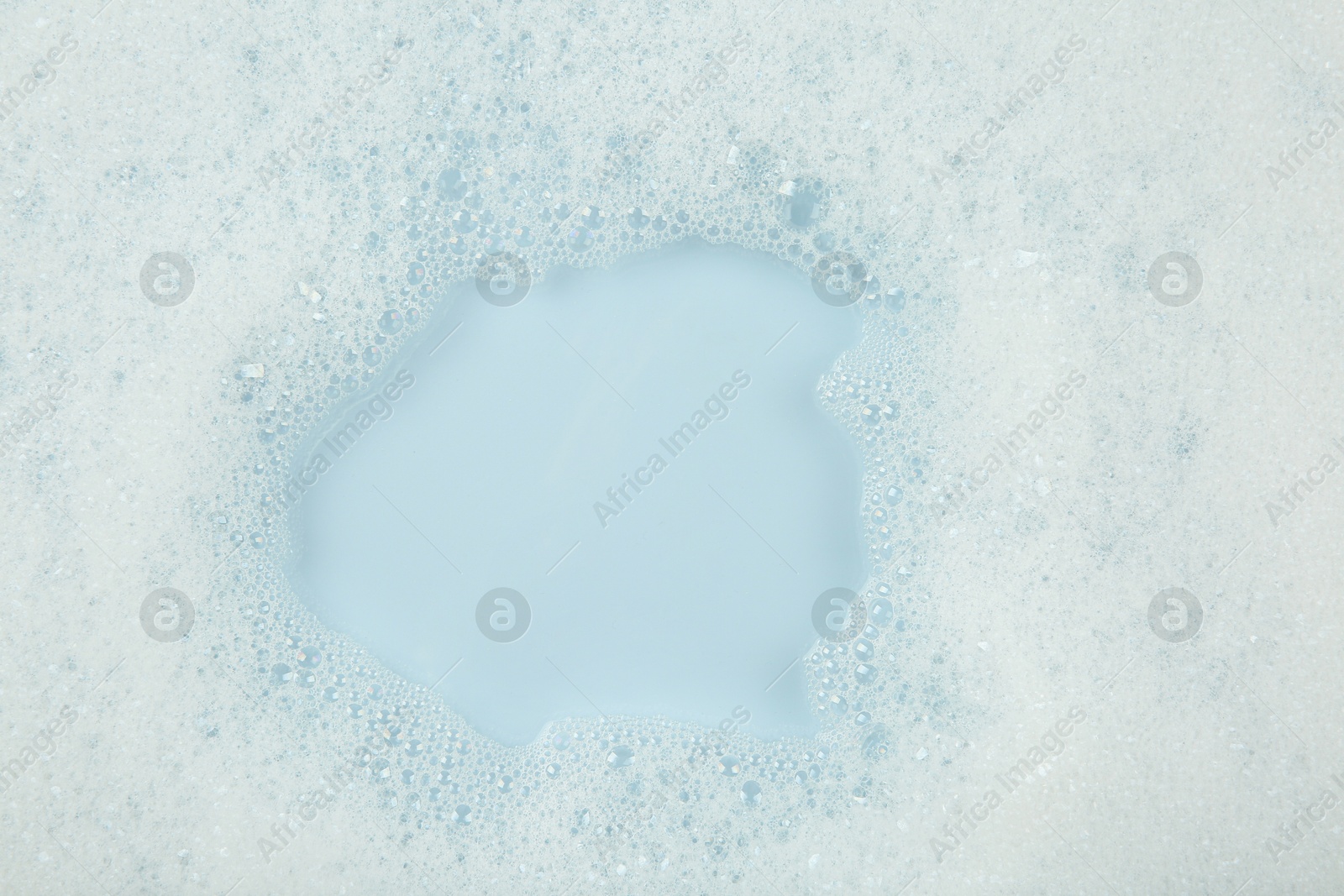 Photo of Washing laundry. Water with foam, top view