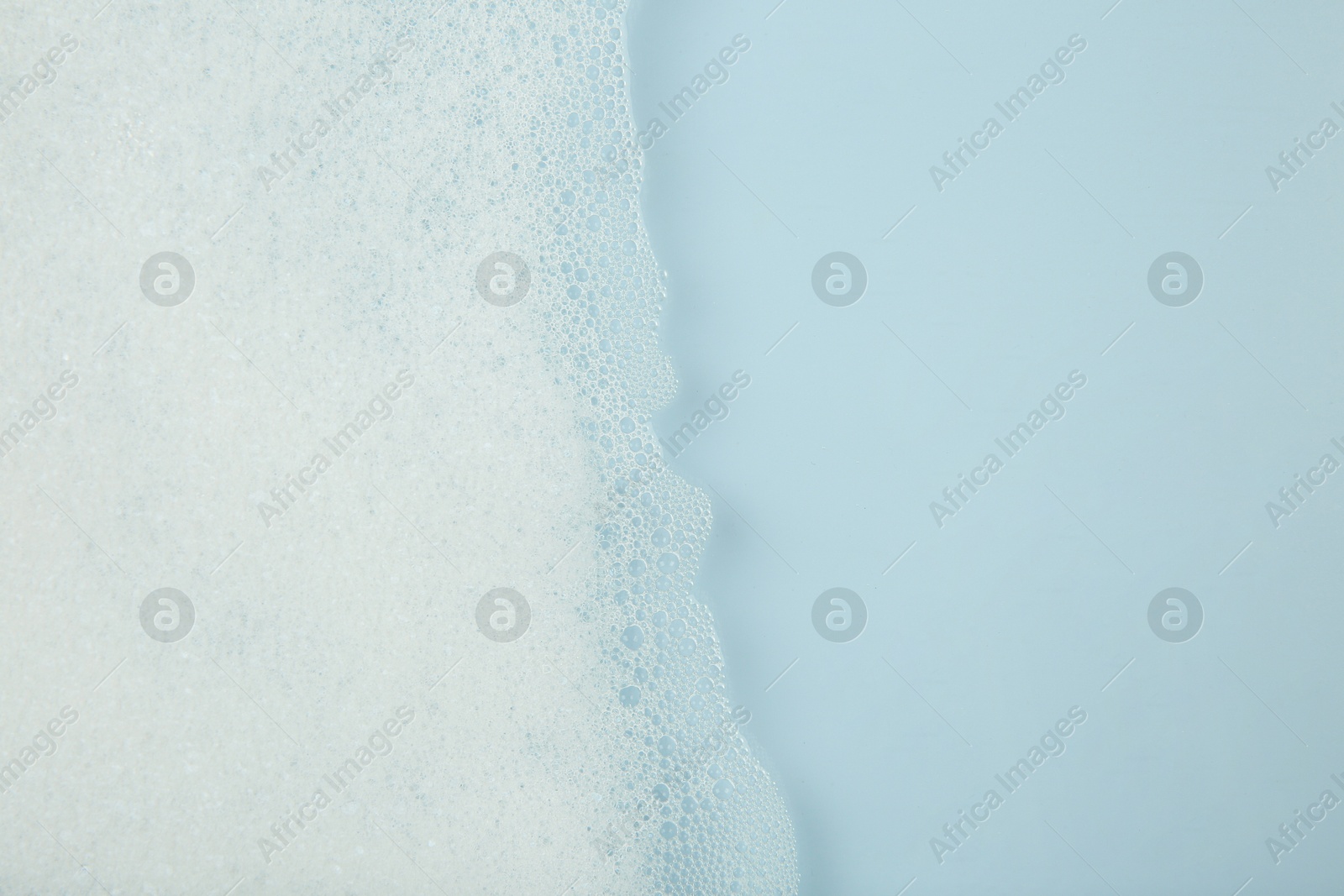 Photo of Washing laundry. Water with foam, top view