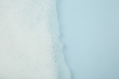 Photo of Washing laundry. Water with foam, top view