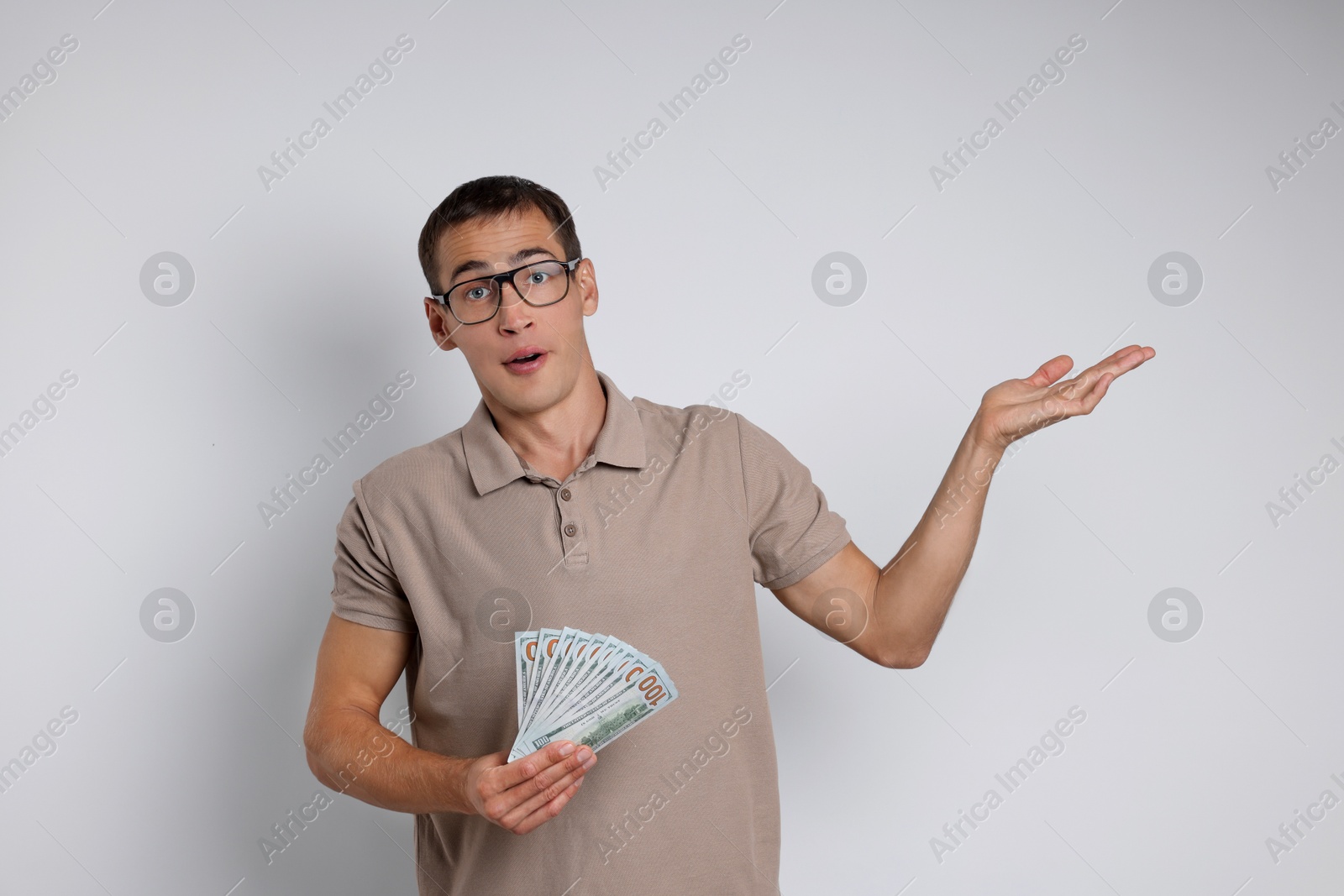 Photo of Man with dollar banknotes on white background