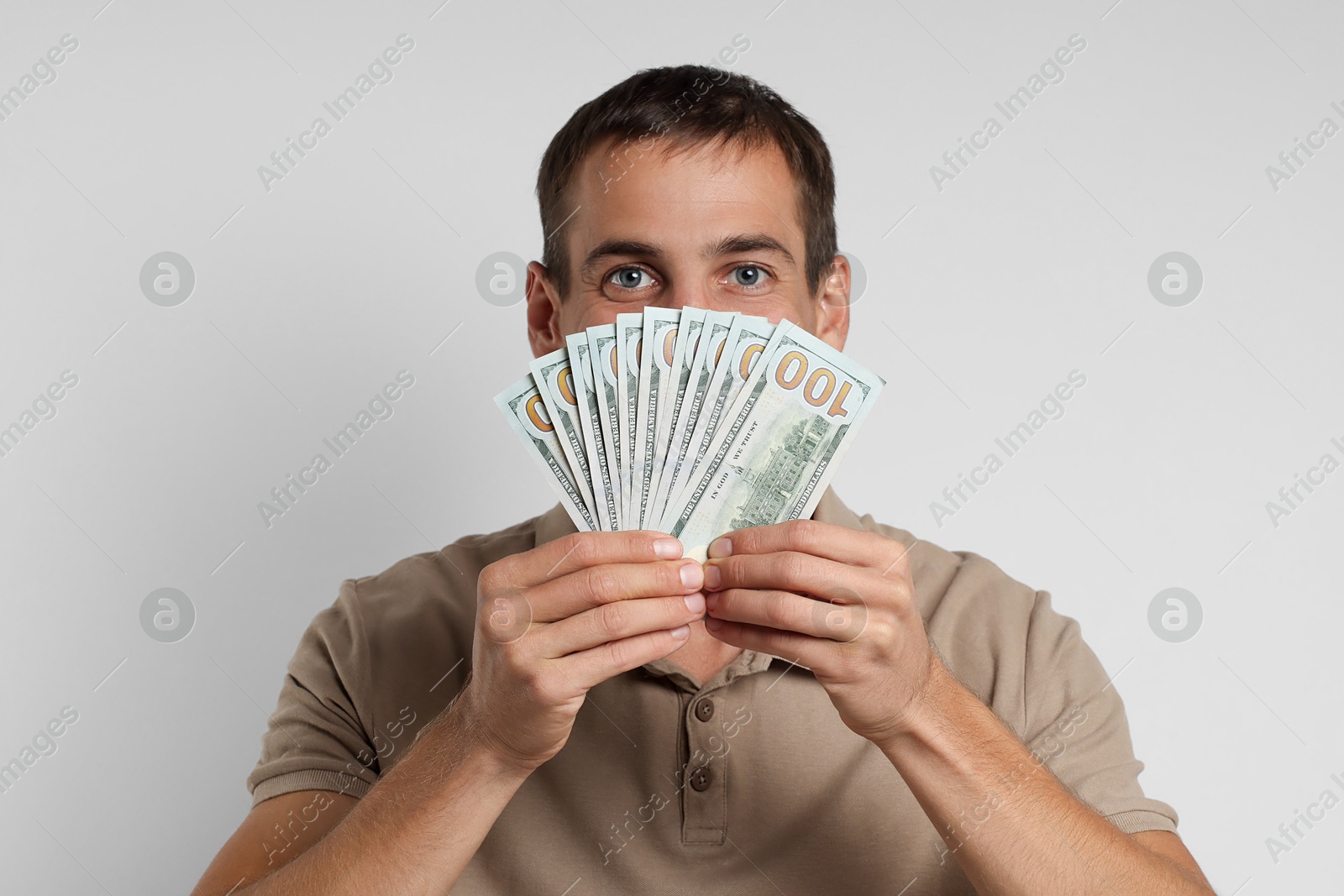 Photo of Man with dollar banknotes on white background