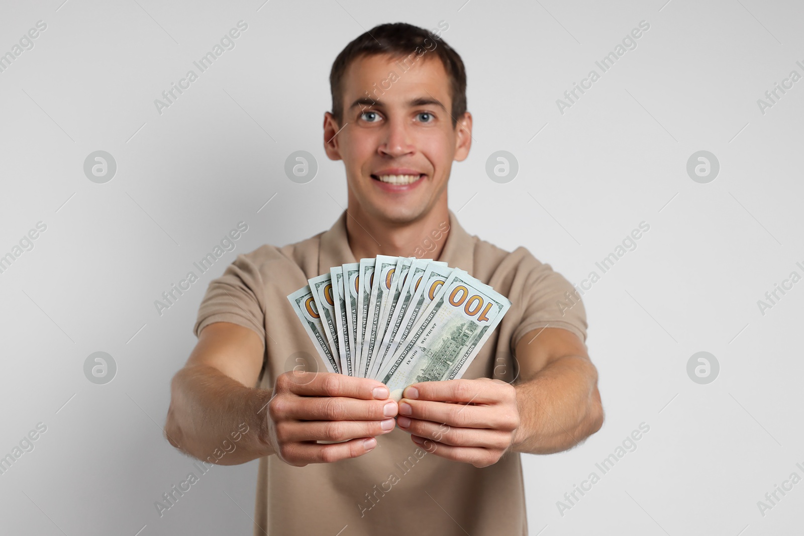 Photo of Man with dollar banknotes on white background