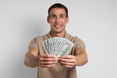 Man with dollar banknotes on white background