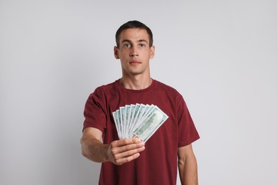 Photo of Man with dollar banknotes on white background