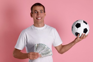 Photo of Happy man with money and soccer ball on pink background