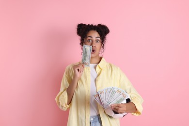 Photo of Shocked woman with money and soccer ball on pink background