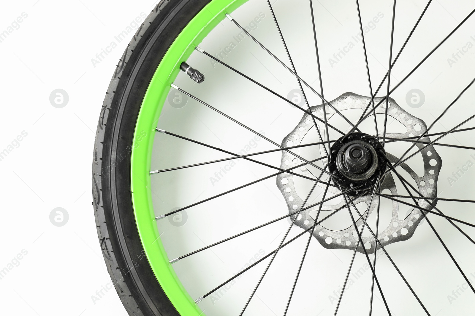 Photo of Bicycle wheel with tire on white background, top view