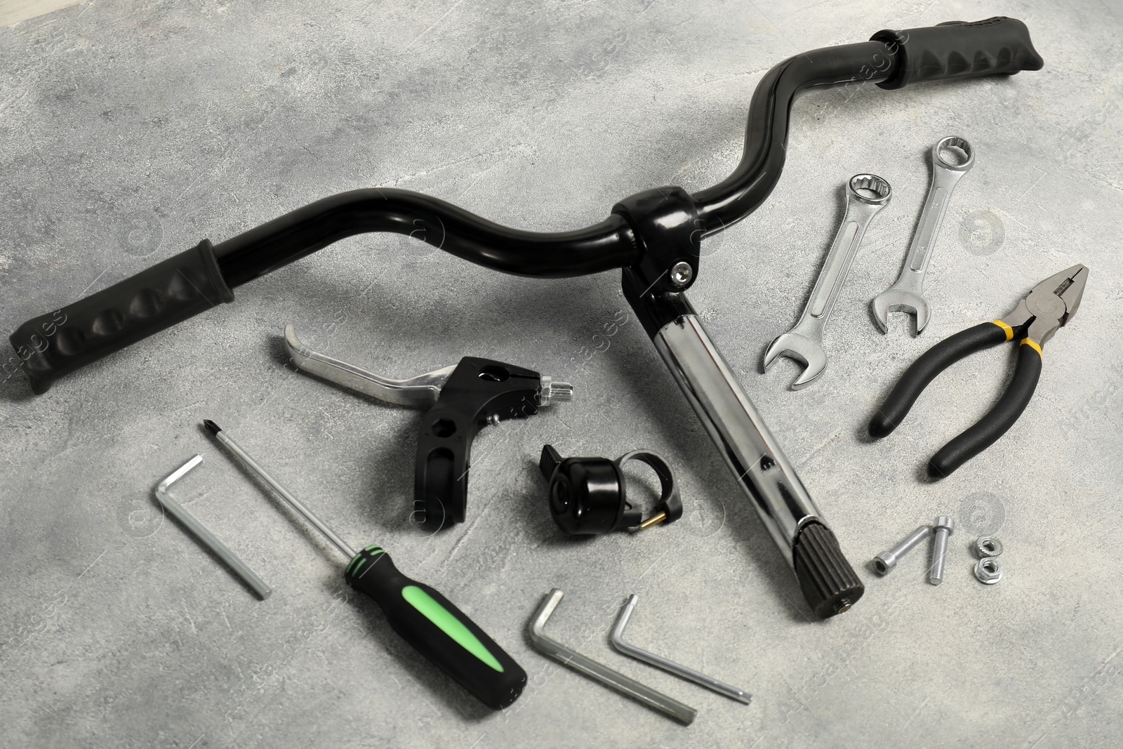 Photo of Parts of bicycle and tools on grey background