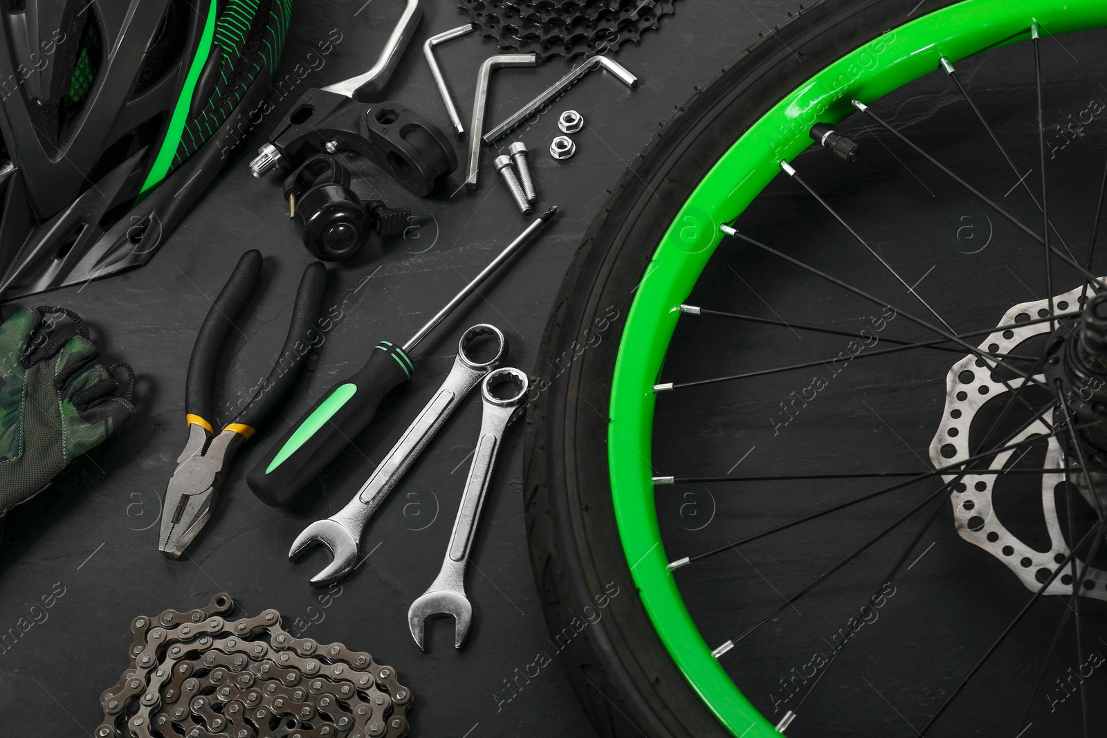 Photo of Parts of bicycle and tools on black background