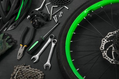 Photo of Parts of bicycle and tools on black background