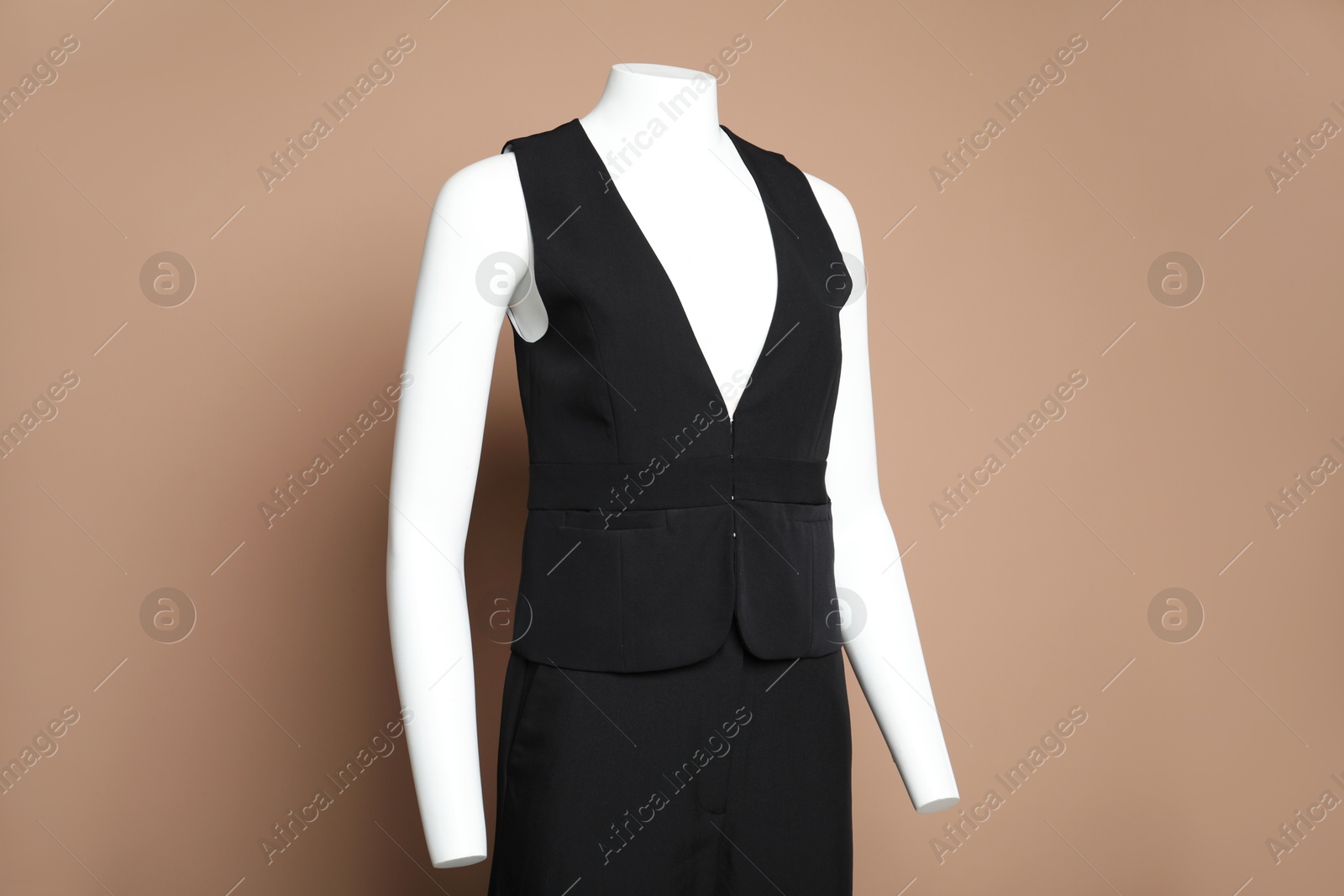 Photo of Female mannequin with stylish black outfit on light brown background