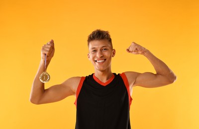 Happy winner with golden medal on yellow background