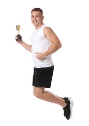 Photo of Happy winner with golden trophy cup jumping on white background