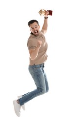 Photo of Happy winner with golden trophy cup jumping on white background