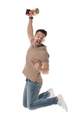 Happy winner with golden trophy cup jumping on white background