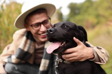 Portrait of cute dog with owner outdoors, selective focus