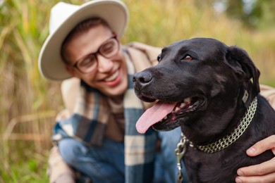 Portrait of cute dog with owner outdoors, selective focus