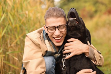 Portrait of smiling man with cute dog outdoors