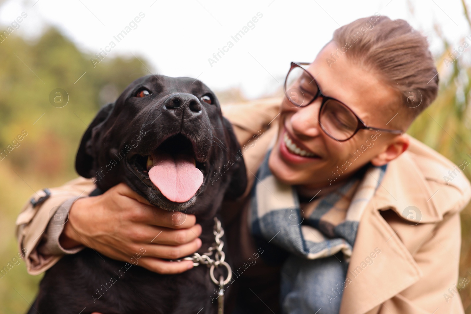 Photo of Portrait of smiling man with cute dog outdoors