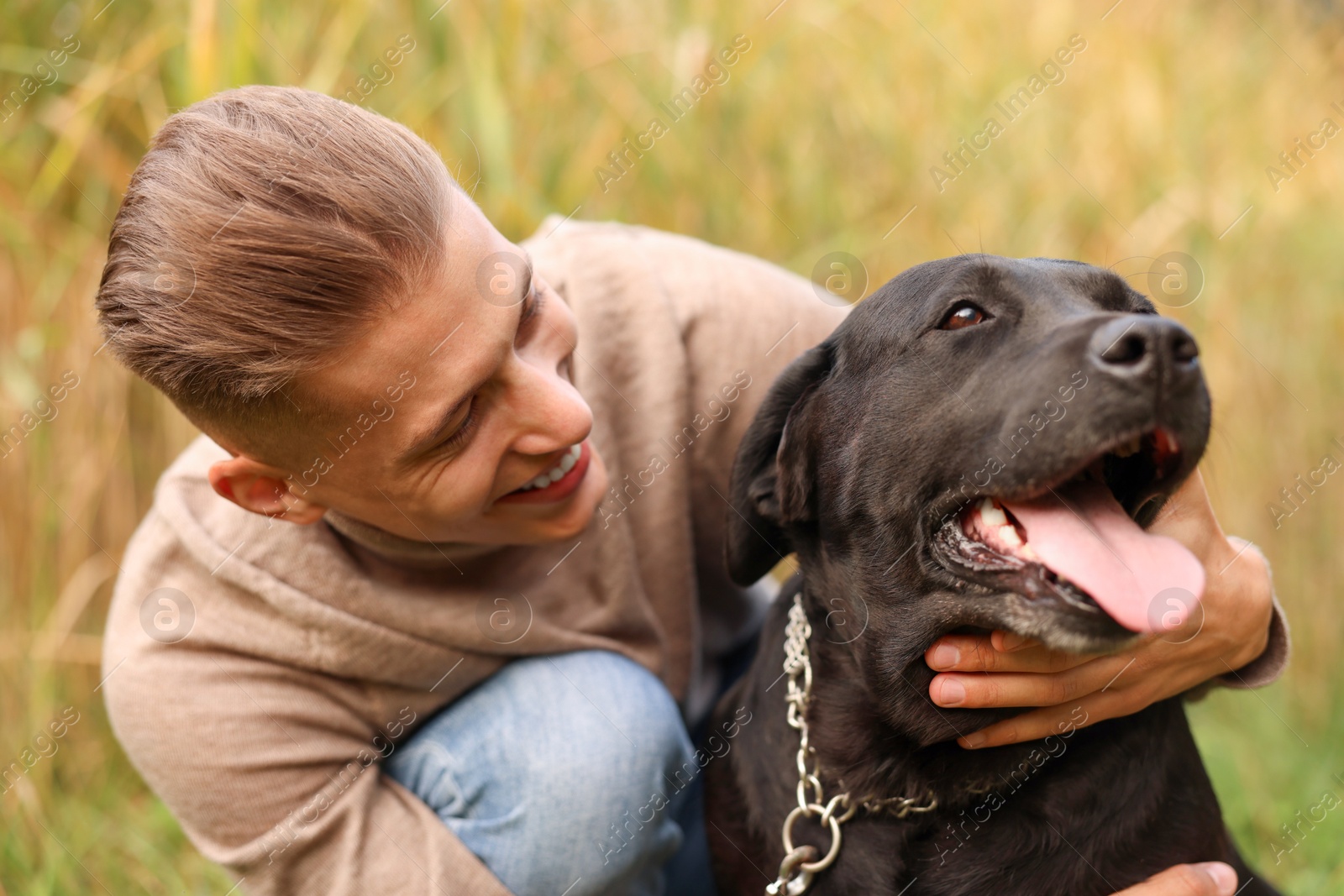 Photo of Portrait of smiling man with cute dog outdoors