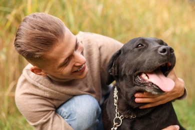 Portrait of smiling man with cute dog outdoors